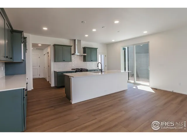 a view of kitchen with refrigerator stove and wooden cabinets