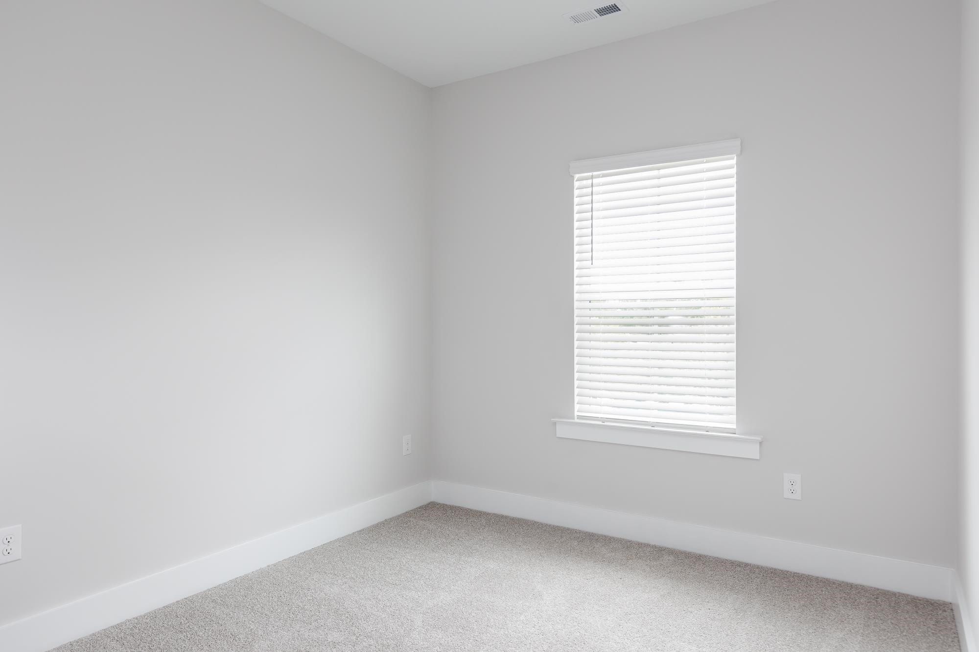 8520 Silsbee Drive Raleigh, NC 27613 - Photo 13 of 18 an empty room with a window