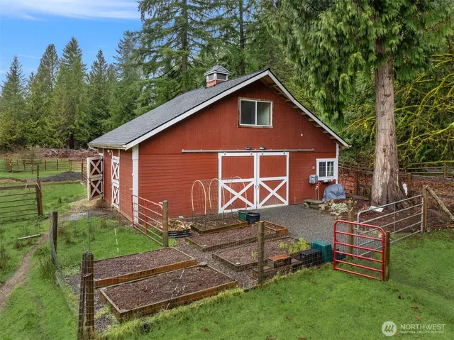 a view of backyard with wooden fence and a large tree
