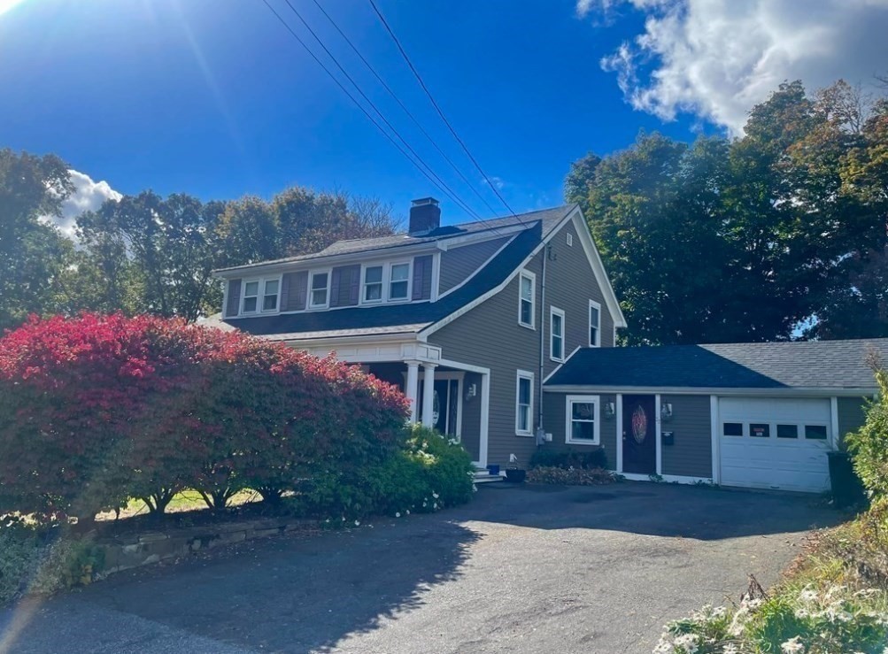 22 Howe Street Hingham, MA 02043 - Photo 5 of 12 a front view of a house with a yard