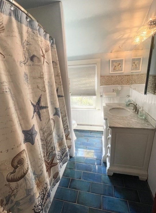 22 Howe Street Hingham, MA 02043 - Photo 10 of 12 a bathroom with a sink and a mirror