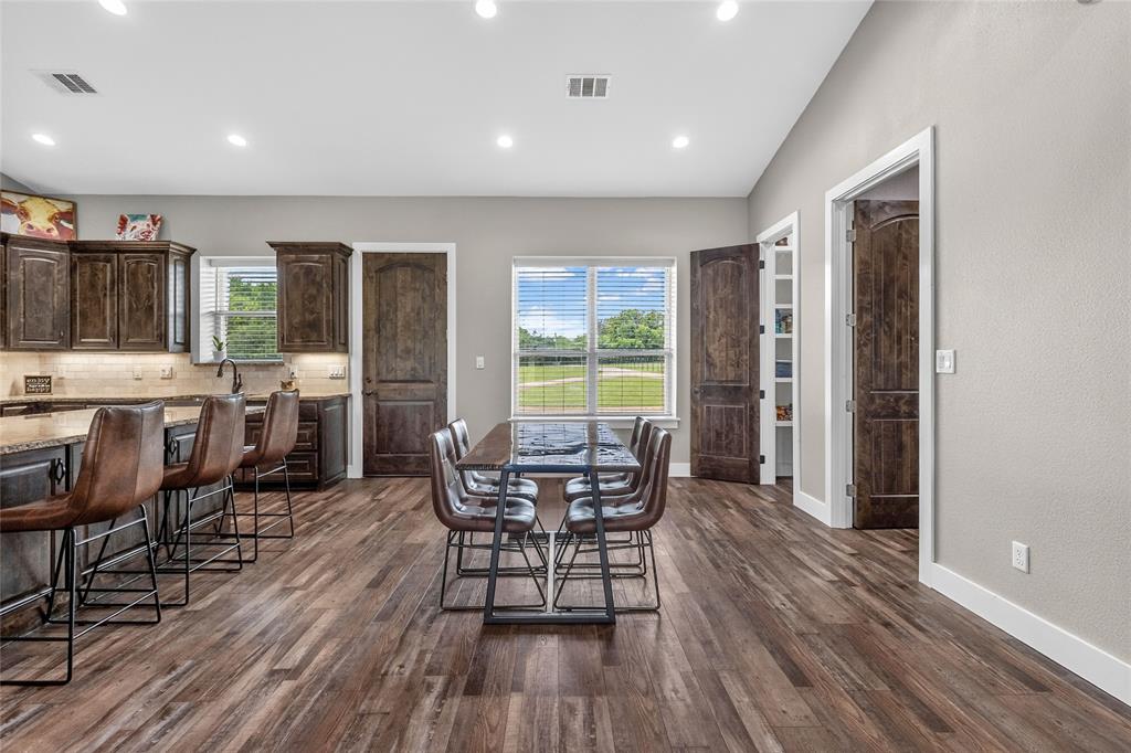 1149 Signal Road Quinlan, TX 75474 - Photo 16 of 40 a view of a dining room with furniture and wooden floor
