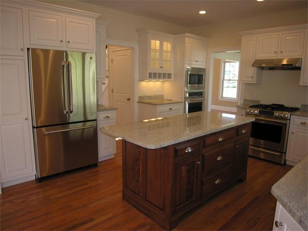 56 Berkshire Road Needham, MA 02492 - Photo 11 of 22 a kitchen with kitchen island granite countertop wooden cabinets and a refrigerator