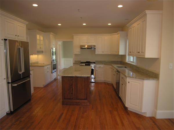 56 Berkshire Road Needham, MA 02492 - Photo 8 of 22 a kitchen with stainless steel appliances granite countertop a refrigerator a sink dishwasher a stove and white cabinets with wooden floor