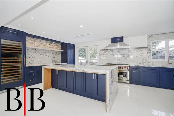 a kitchen with granite countertop cabinets and wooden floor