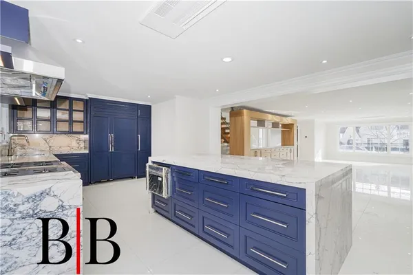 a kitchen with stainless steel appliances granite countertop a stove and a wooden cabinets