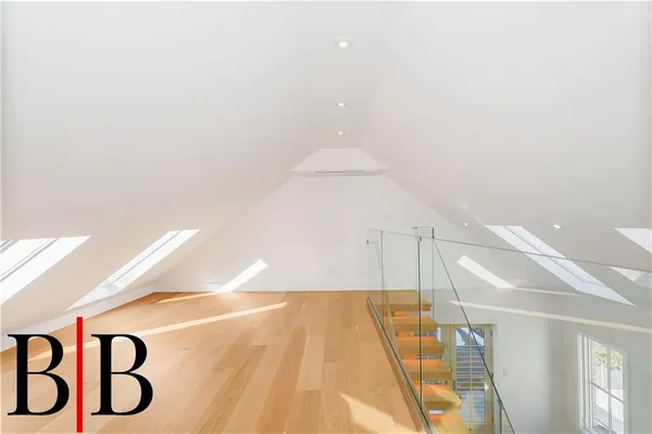 a living room with a floor to ceiling window and stairs
