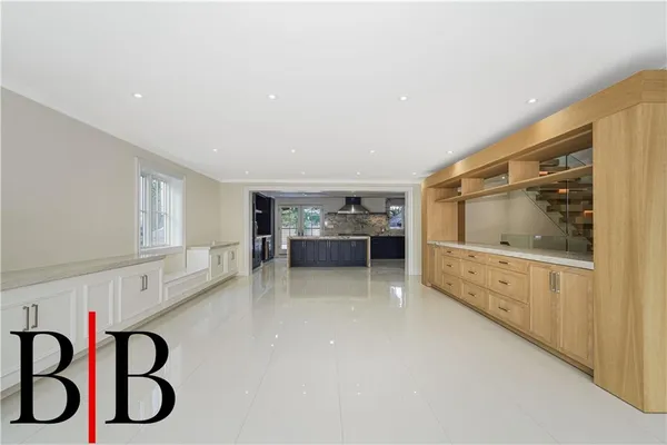 a living room with furniture and view of kitchen