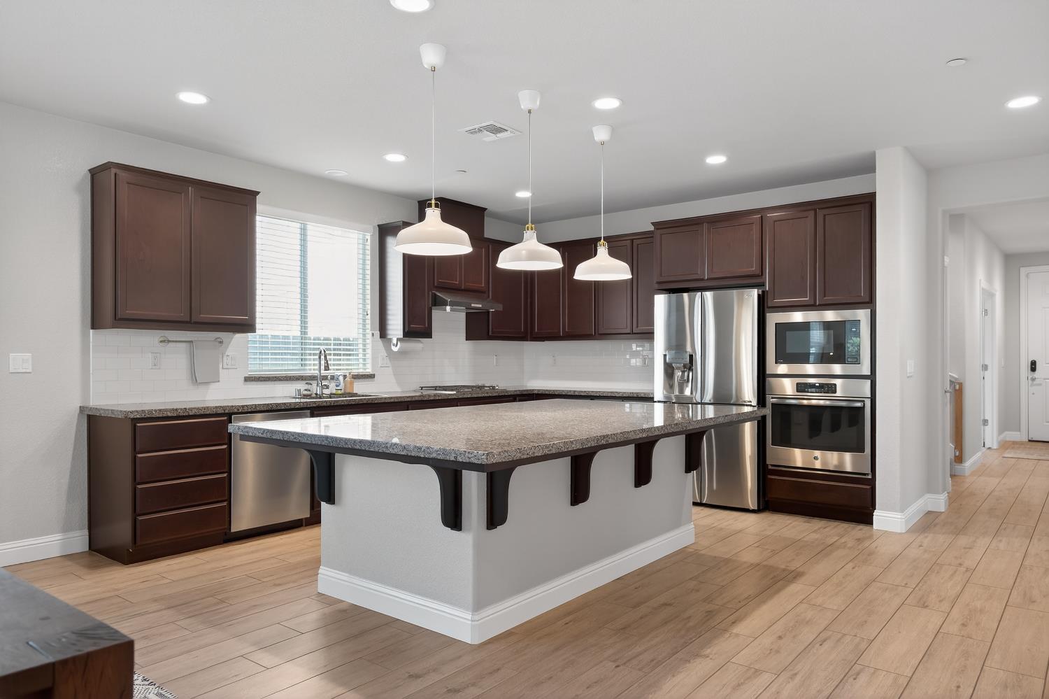 183 Michael Cox Lane Tracy, CA 95377 - Photo 11 of 35 a kitchen with stainless steel appliances granite countertop a stove and a sink