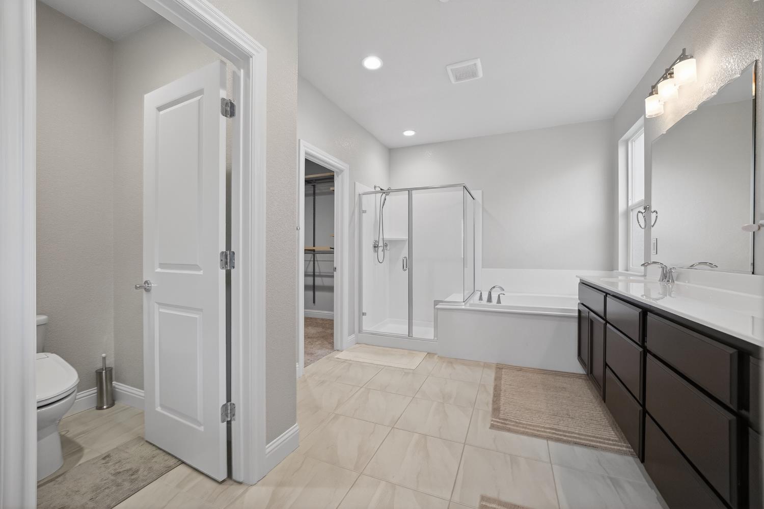 183 Michael Cox Lane Tracy, CA 95377 - Photo 20 of 35 a bathroom with a granite countertop sink a toilet and shower