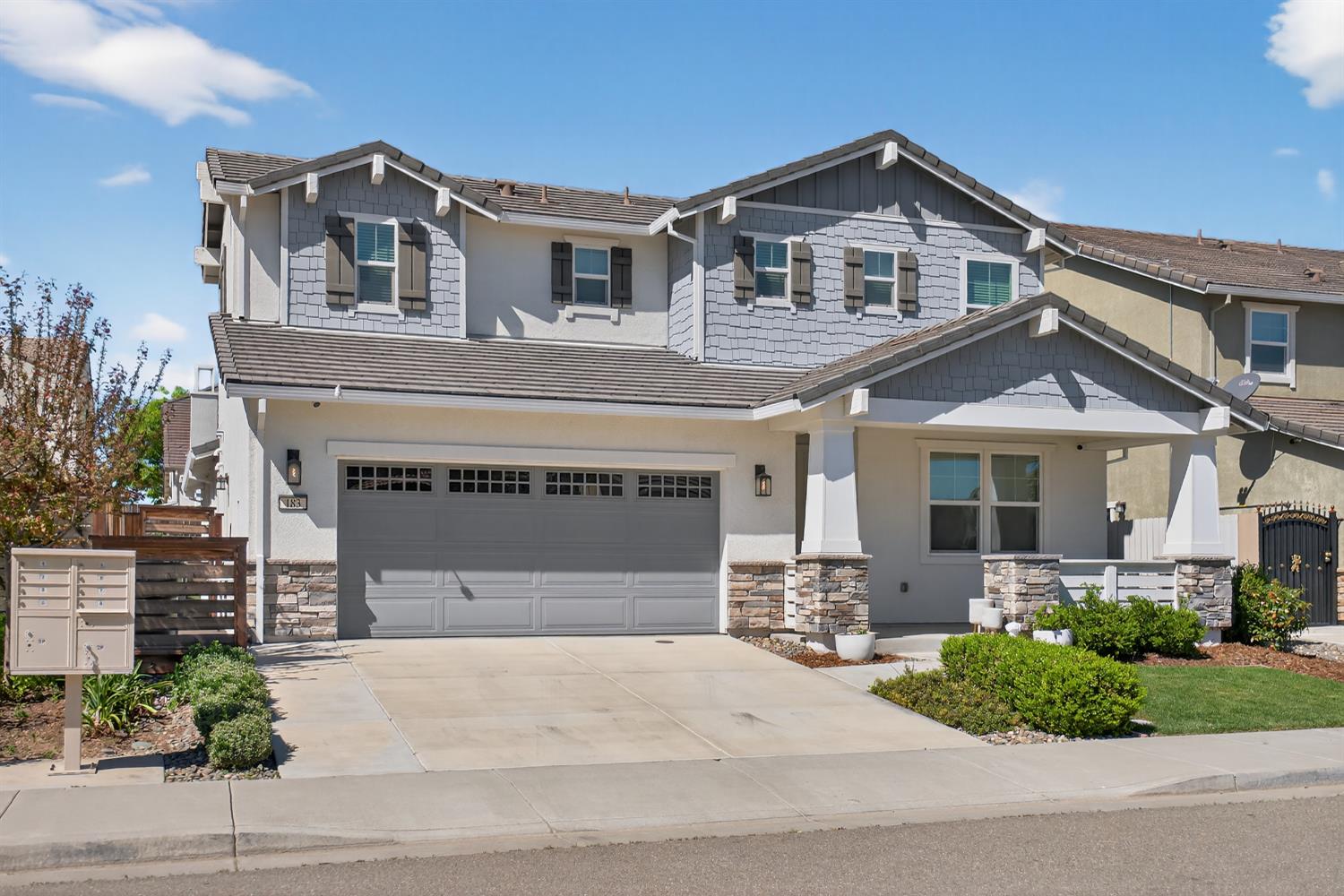183 Michael Cox Lane Tracy, CA 95377 - Photo 3 of 35 a front view of a house with a garden and entryway