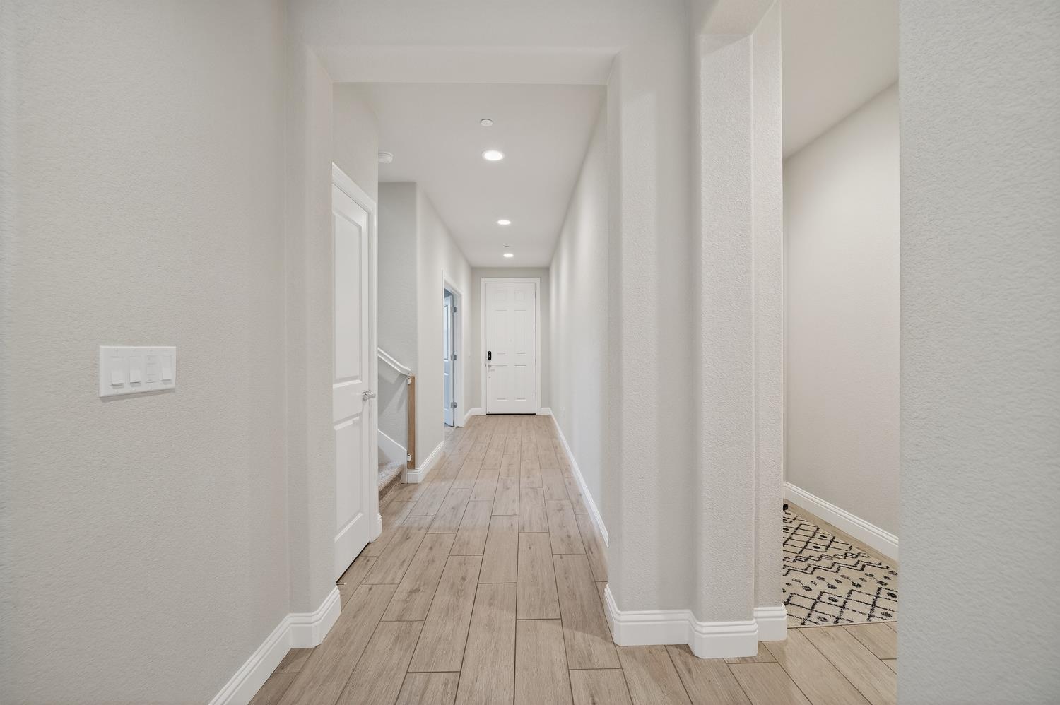 183 Michael Cox Lane Tracy, CA 95377 - Photo 5 of 35 a view of a hallway with wooden floor and staircase