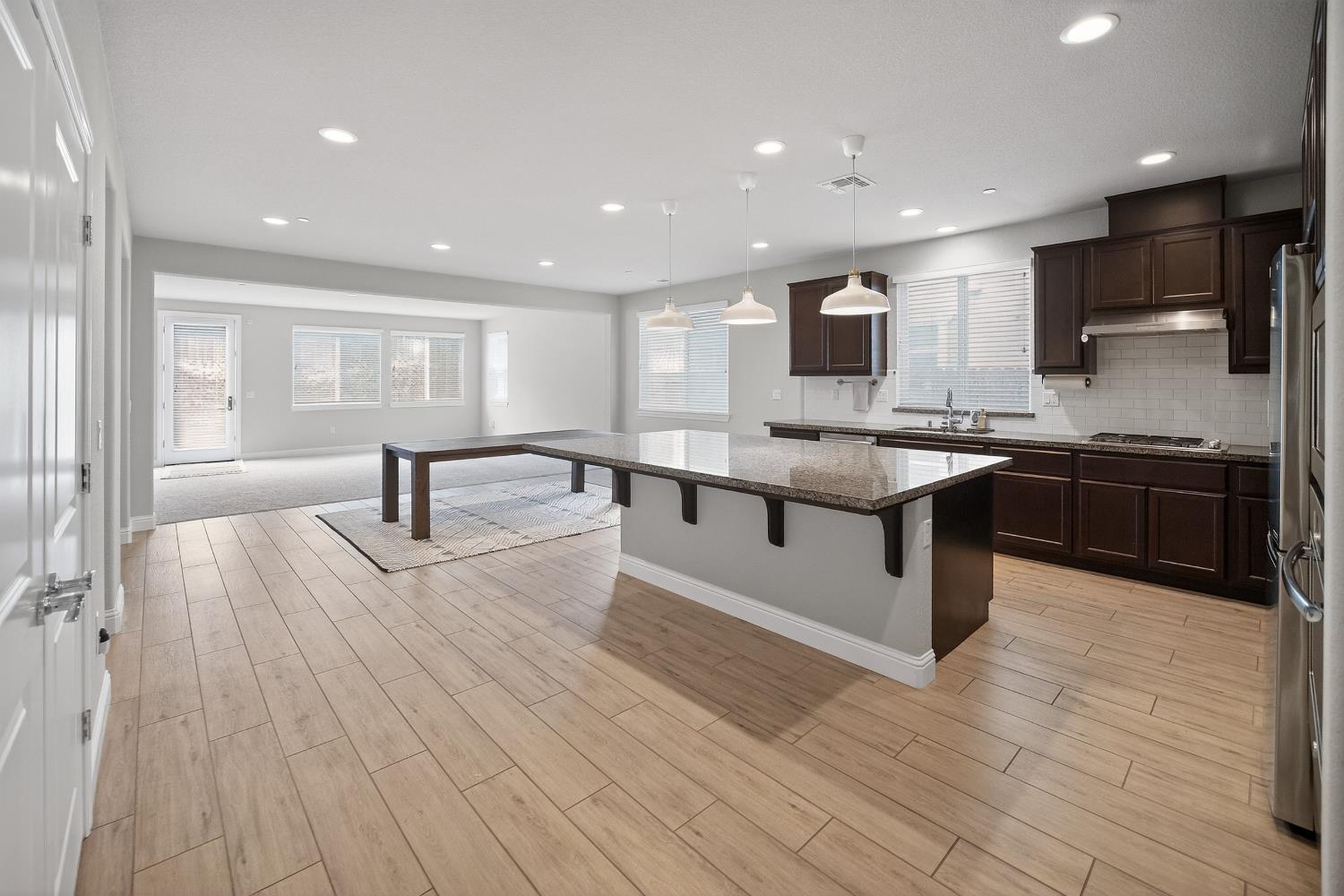 183 Michael Cox Lane Tracy, CA 95377 - Photo 9 of 35 a large kitchen with stainless steel appliances granite countertop a lot of counter space and a sink