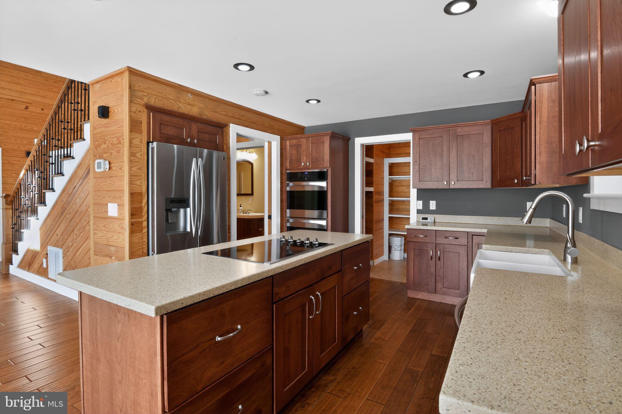 6857 Fire Tower Road Hebron, MD 21830 - Photo 14 of 30 a large kitchen with kitchen island a sink stainless steel appliances and cabinets