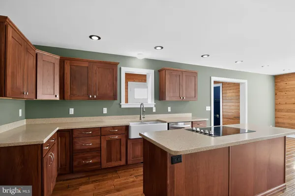 a kitchen with a sink cabinets and window