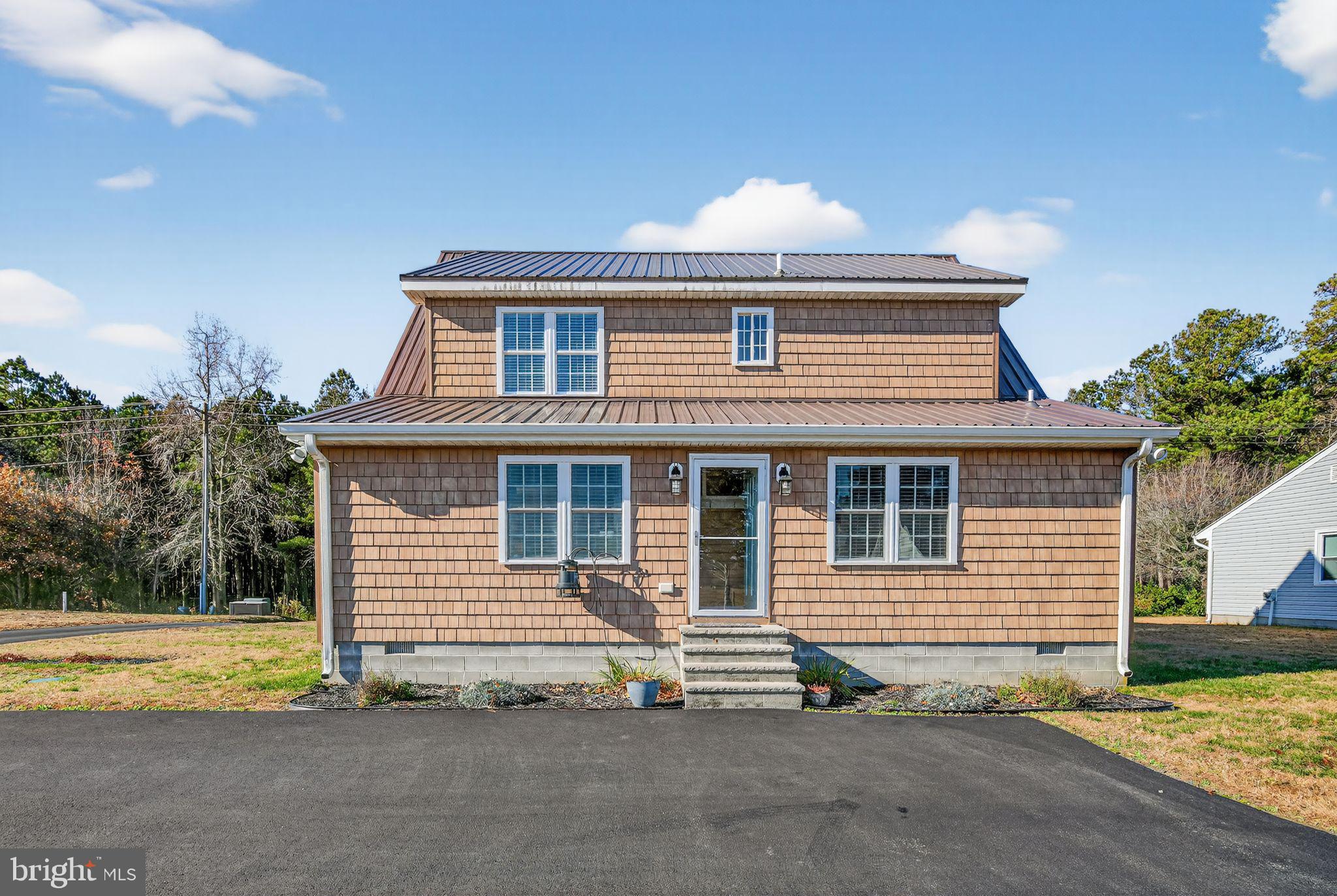 6857 Fire Tower Road Hebron, MD 21830 - Photo 2 of 30 a front view of a house with a yard