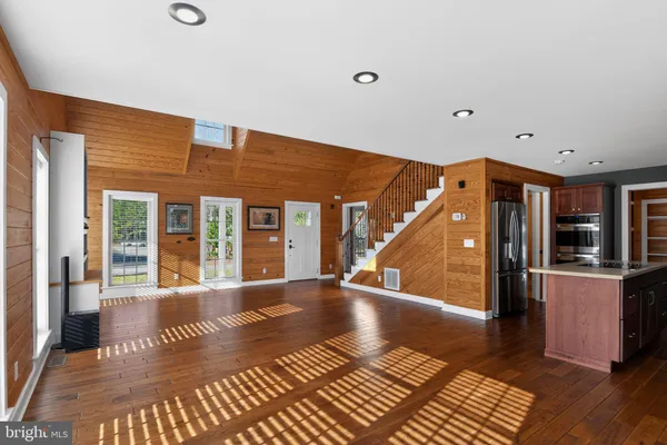 a view of an entryway with wooden floor and door