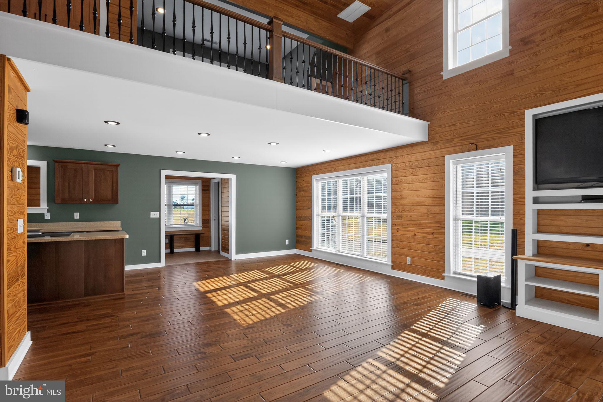 6857 Fire Tower Road Hebron, MD 21830 - Photo 9 of 30 a view of an empty room with a kitchen stove and wooden floor
