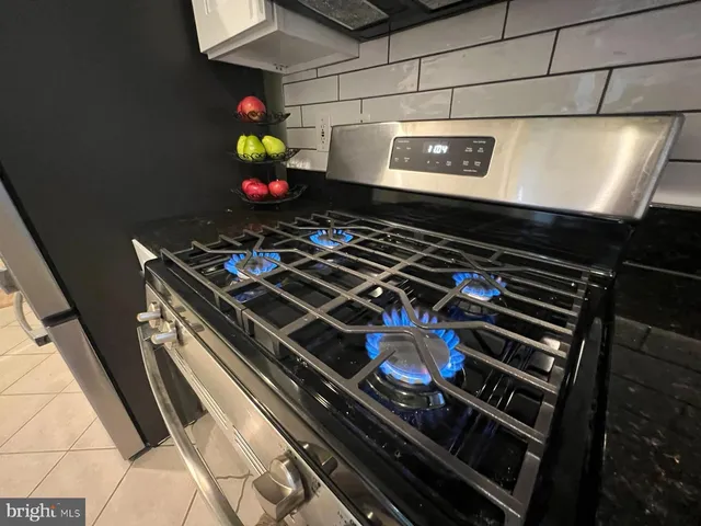 a kitchen with stainless steel appliances a refrigerator and a stove