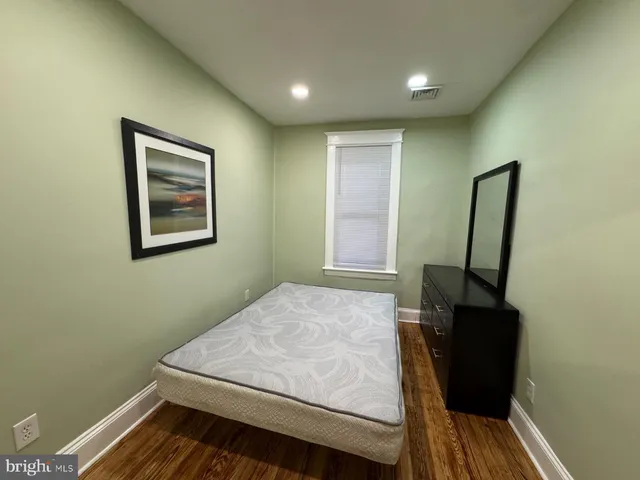a bedroom with a bed and window