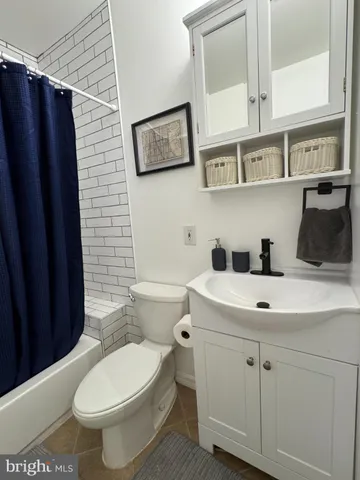 a living room with furniture a clock and wall clock