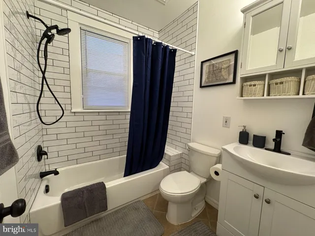 a bathroom with a double vanity sink toilet and shower