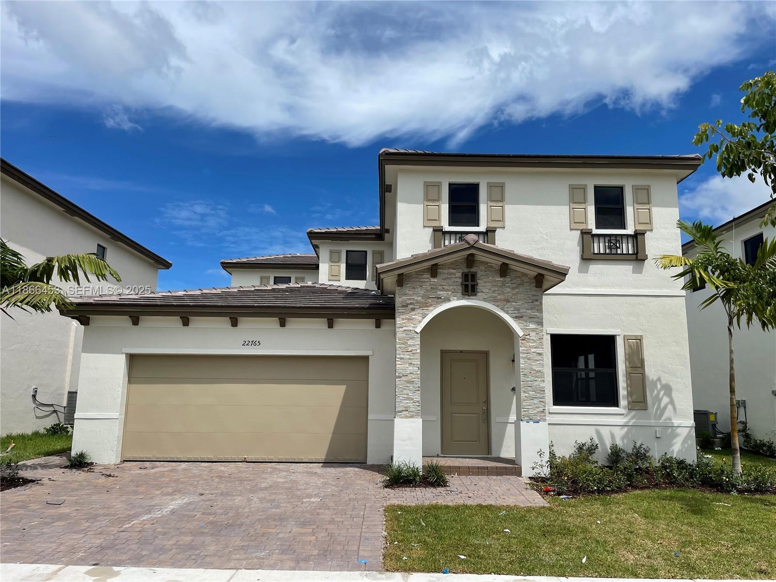 22765 Southwest 131st Place, Unit 22765 Miami, FL 33170 - Photo 1 of 2 a front view of a house with garden
