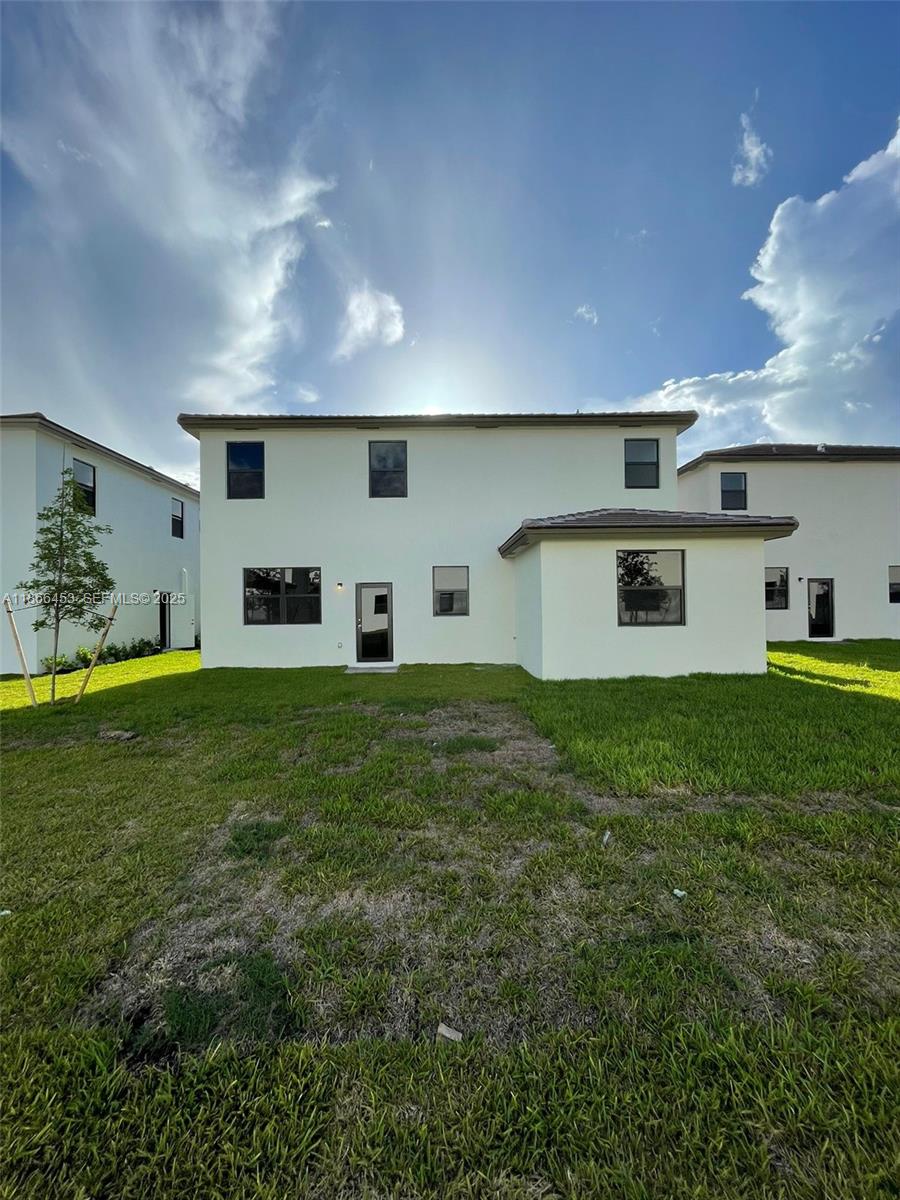 22765 Southwest 131st Place, Unit 22765 Miami, FL 33170 - Photo 2 of 2 a front view of a house with a yard