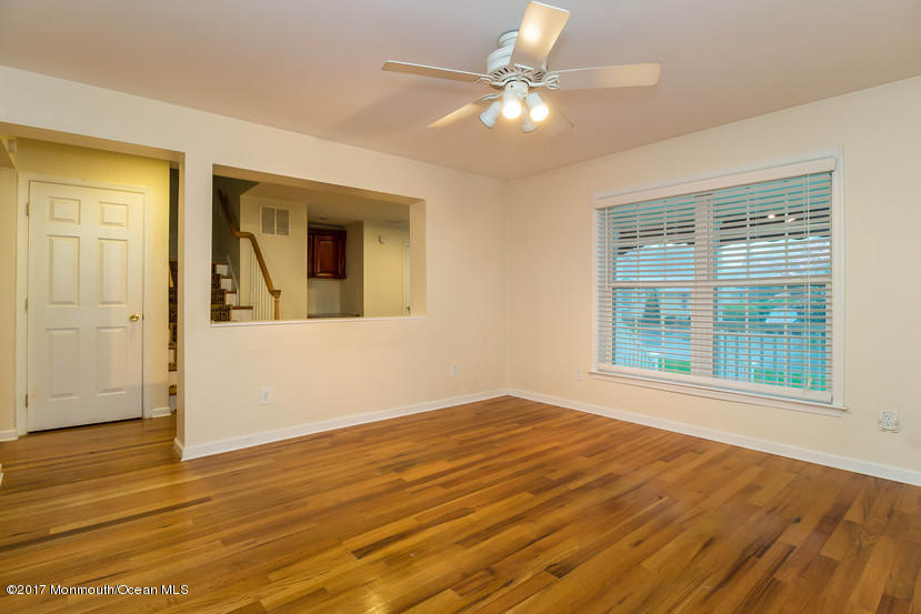 1320 Squirrel Road Wall, NJ 07719 - Photo 12 of 24 a view of an empty room with wooden floor and a window