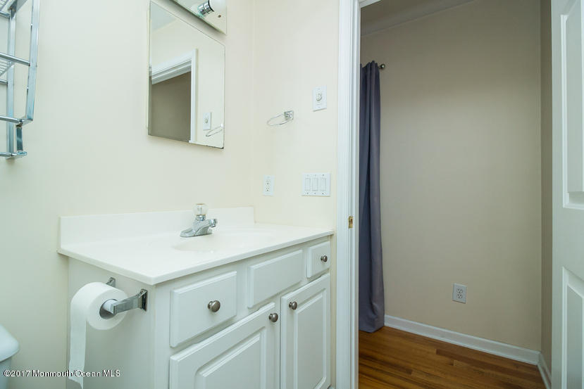 1320 Squirrel Road Wall, NJ 07719 - Photo 14 of 24 a bathroom with a sink and a mirror