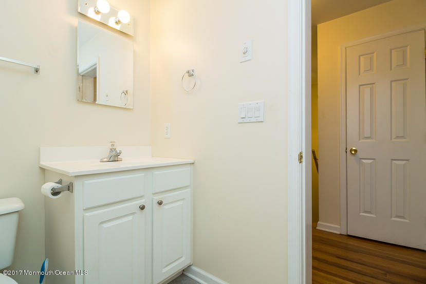 1320 Squirrel Road Wall, NJ 07719 - Photo 16 of 24 a bathroom with a sink and a mirror