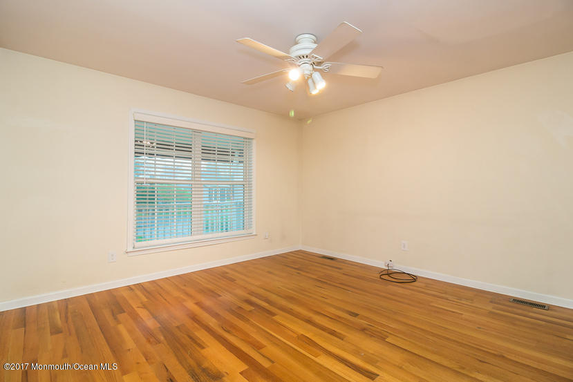 1320 Squirrel Road Wall, NJ 07719 - Photo 17 of 24 a view of an empty room with wooden floor and a window
