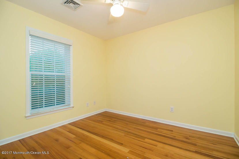 1320 Squirrel Road Wall, NJ 07719 - Photo 19 of 24 a view of an empty room with wooden floor and a window