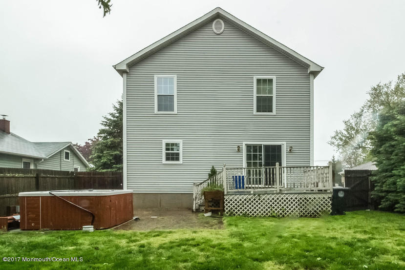 1320 Squirrel Road Wall, NJ 07719 - Photo 22 of 24 a front view of a house with a garden