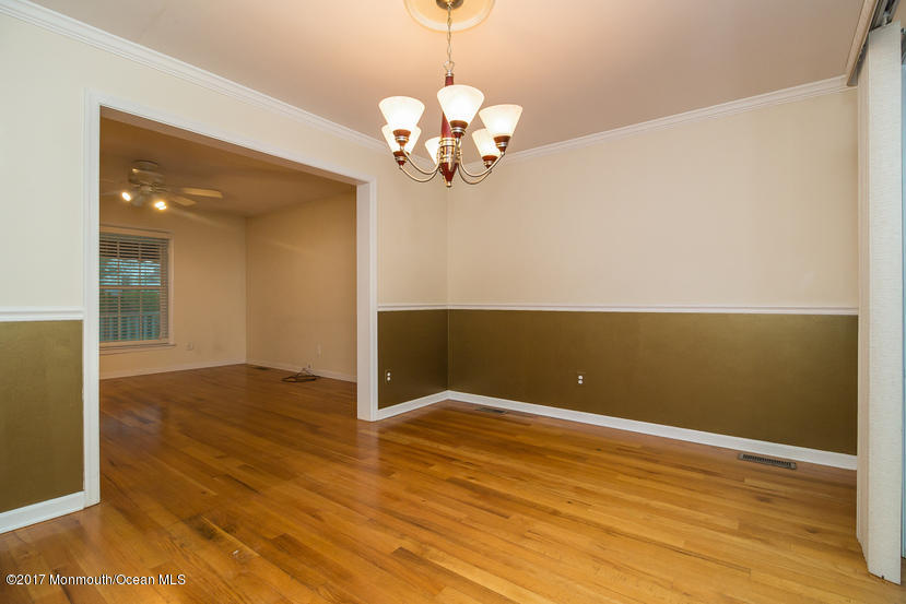 1320 Squirrel Road Wall, NJ 07719 - Photo 8 of 24 a view of wooden floor and chandelier in a room