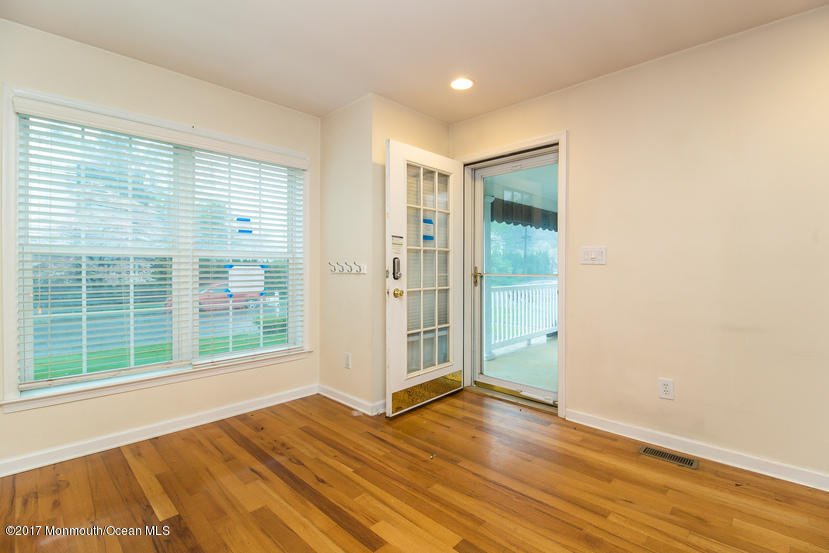 1320 Squirrel Road Wall, NJ 07719 - Photo 9 of 24 an empty room with wooden floor and windows