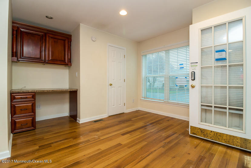 1320 Squirrel Road Wall, NJ 07719 - Photo 10 of 24 a view of empty room with wooden floor and fan