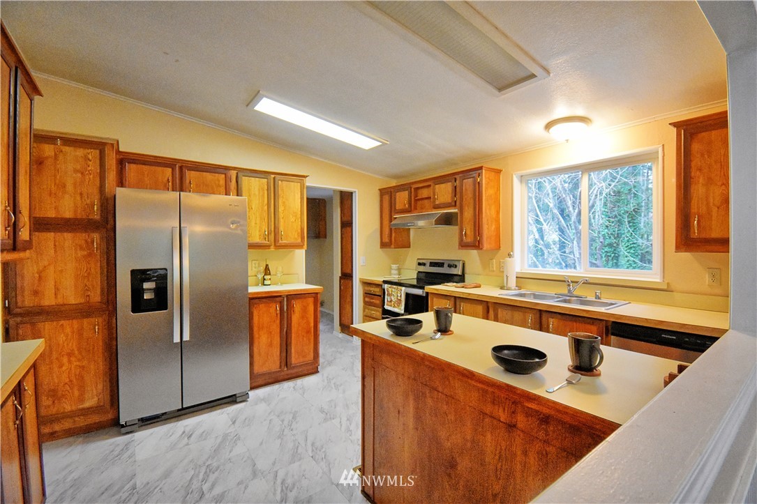 111 East Sleaford Road Shelton, WA 98584 - Photo 4 of 32 a kitchen with stainless steel appliances a sink a stove a refrigerator and cabinets