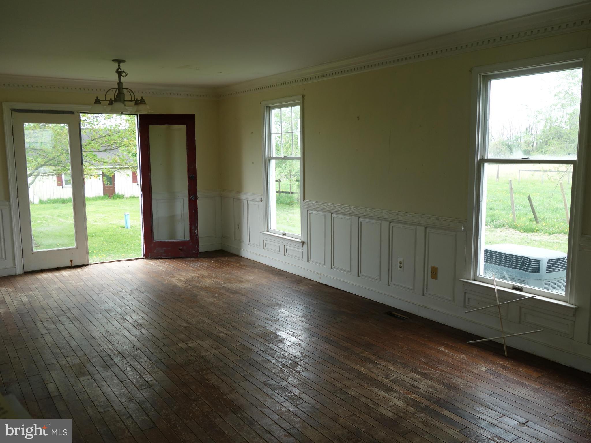7235 Keysville Road Keymar, MD 21757 - Photo 5 of 21 a view of an empty room with wooden floor and a window