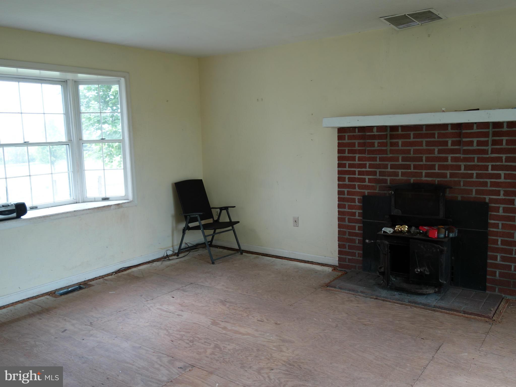7235 Keysville Road Keymar, MD 21757 - Photo 7 of 21 a living room with furniture and a fireplace