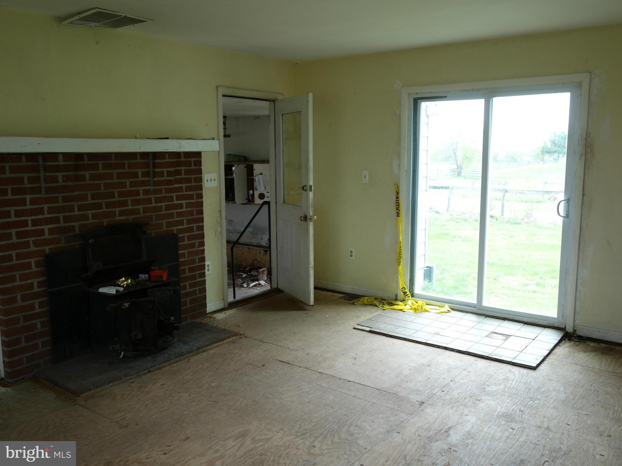 7235 Keysville Road Keymar, MD 21757 - Photo 8 of 21 a view of an empty room with a fireplace