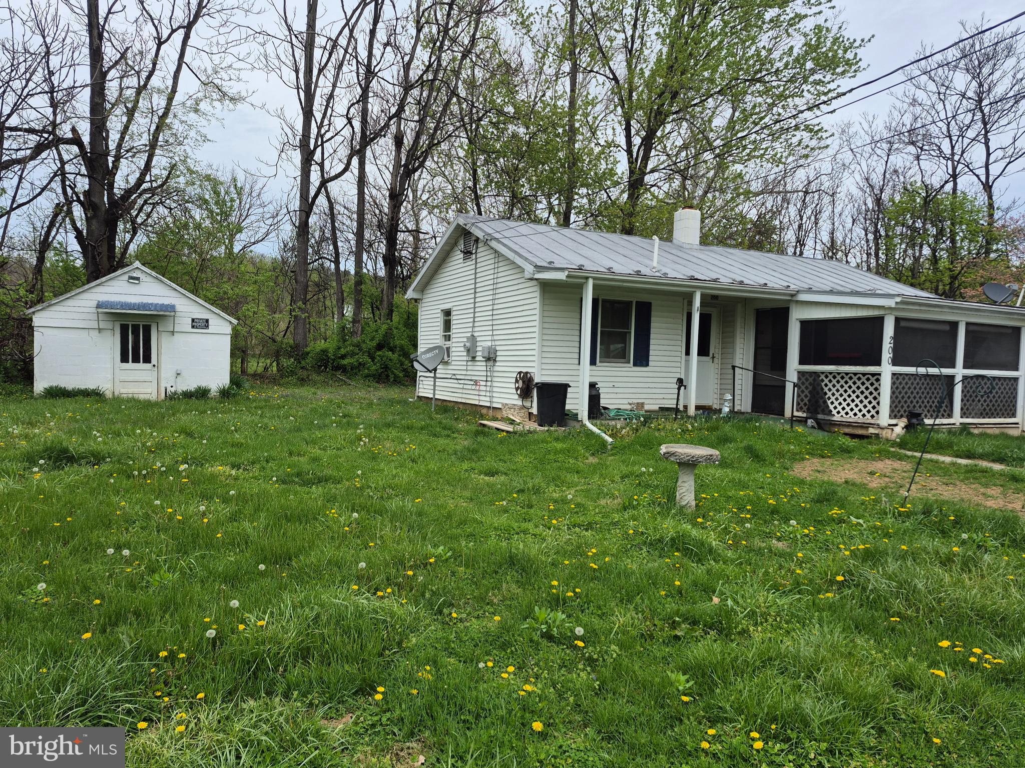 200 Middle Lane Gore, VA 22637 - Photo 2 of 5 a front view of a house with a garden and trees