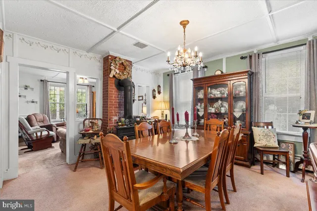 a view of a dining room with furniture and chandelier
