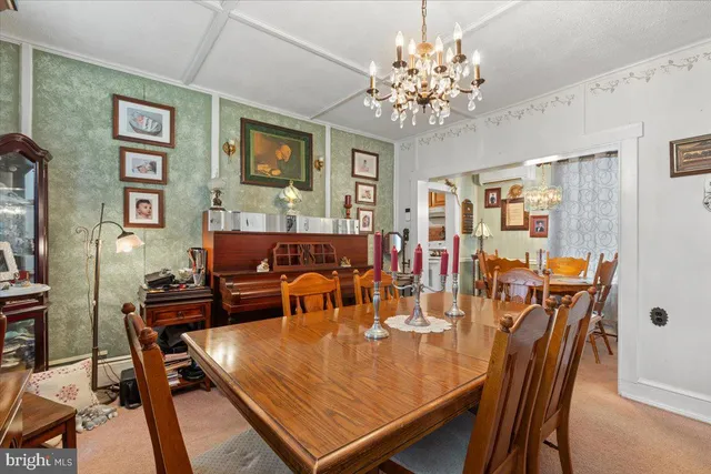 a view of a dining room with furniture and chandelier