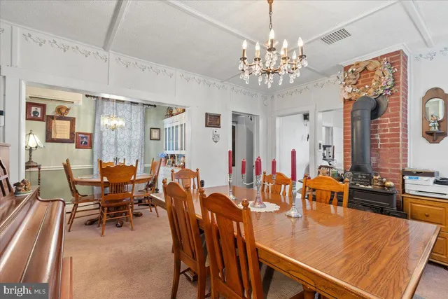 a view of a dining room with furniture and chandelier