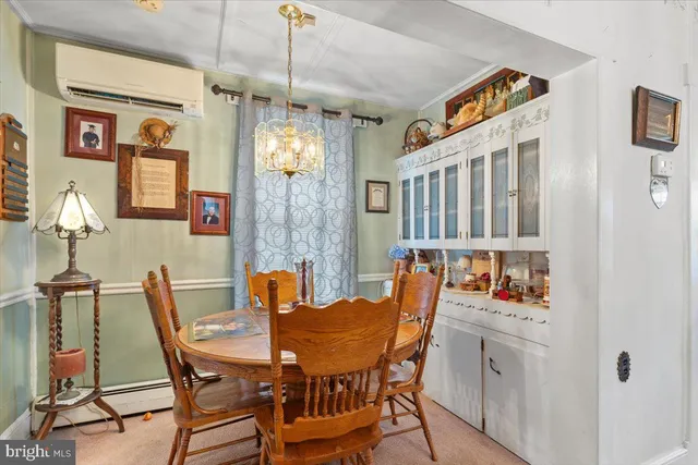 a view of a dining room with furniture and chandelier