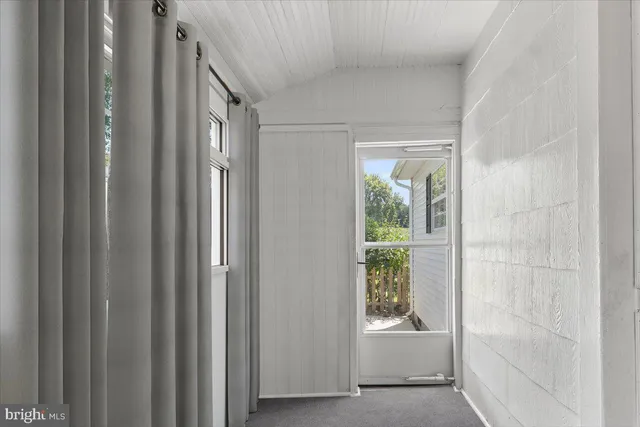 a room with painting on wall and a mirror