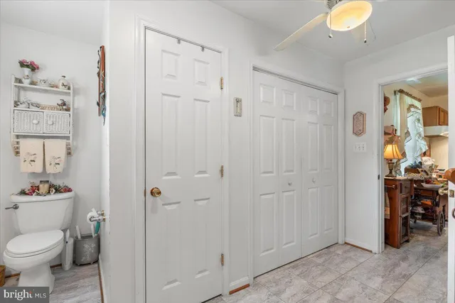a view of a hallway with wooden floor and stairs