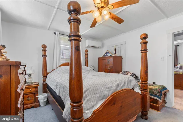 a bedroom with a bed and a large mirror