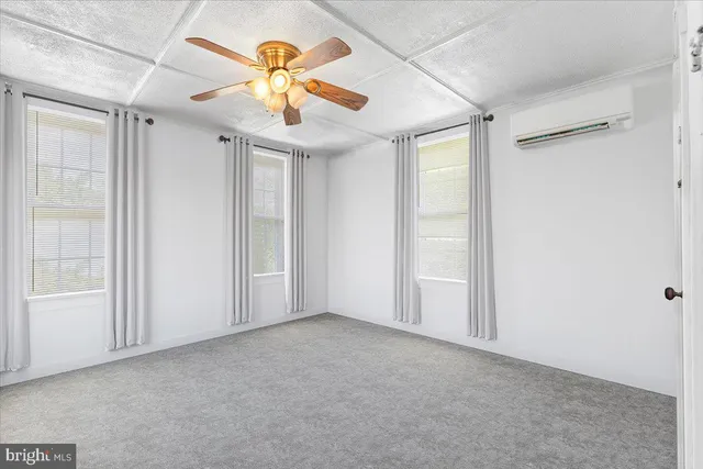 a bedroom with bed and a window